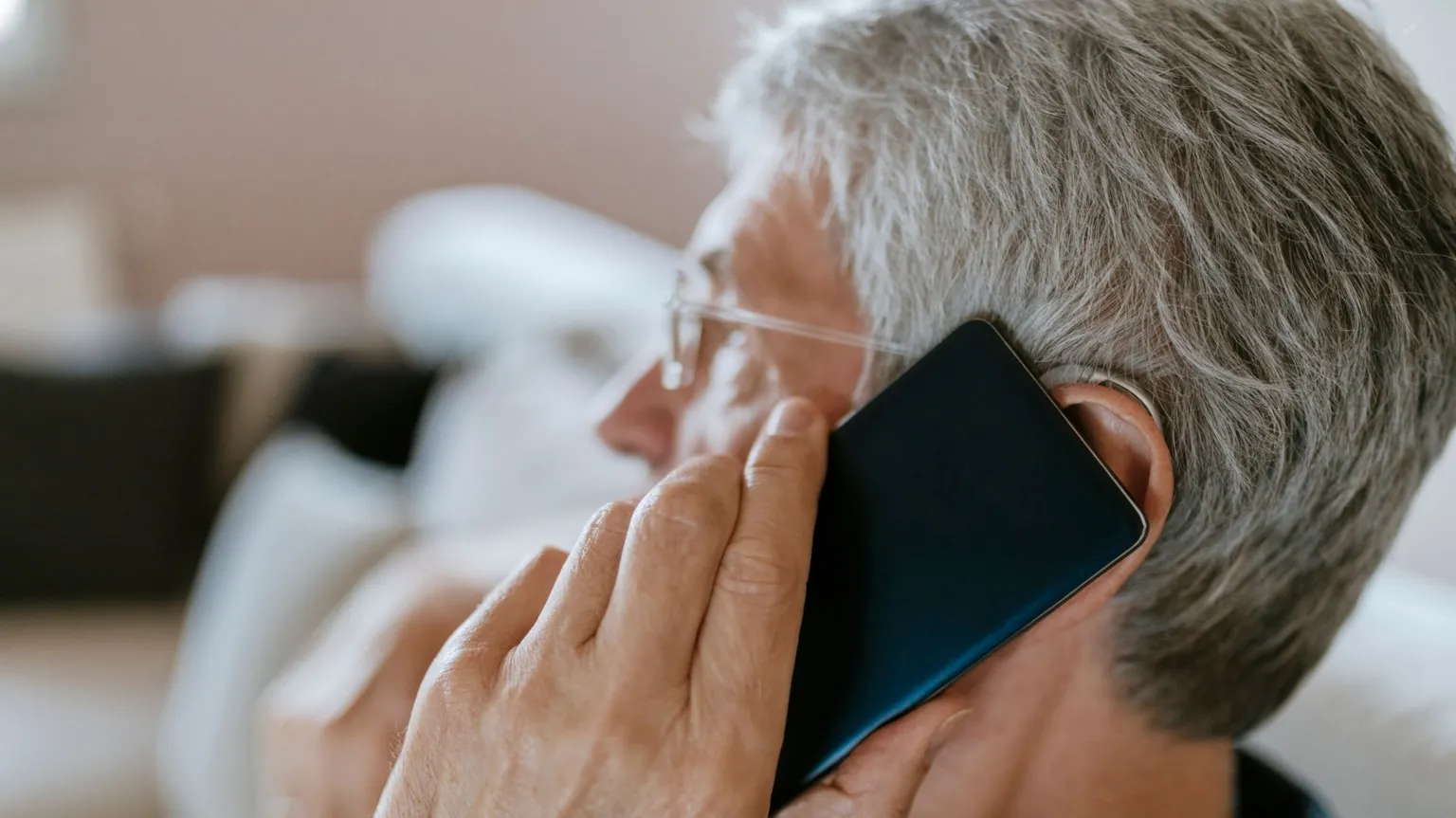 Illustrative photograph of an older person receiving a telephone call