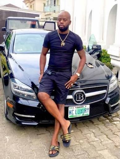 Supplied portrait of Afolabi Kazeem Michael, also known as KC Luxury, beside a car