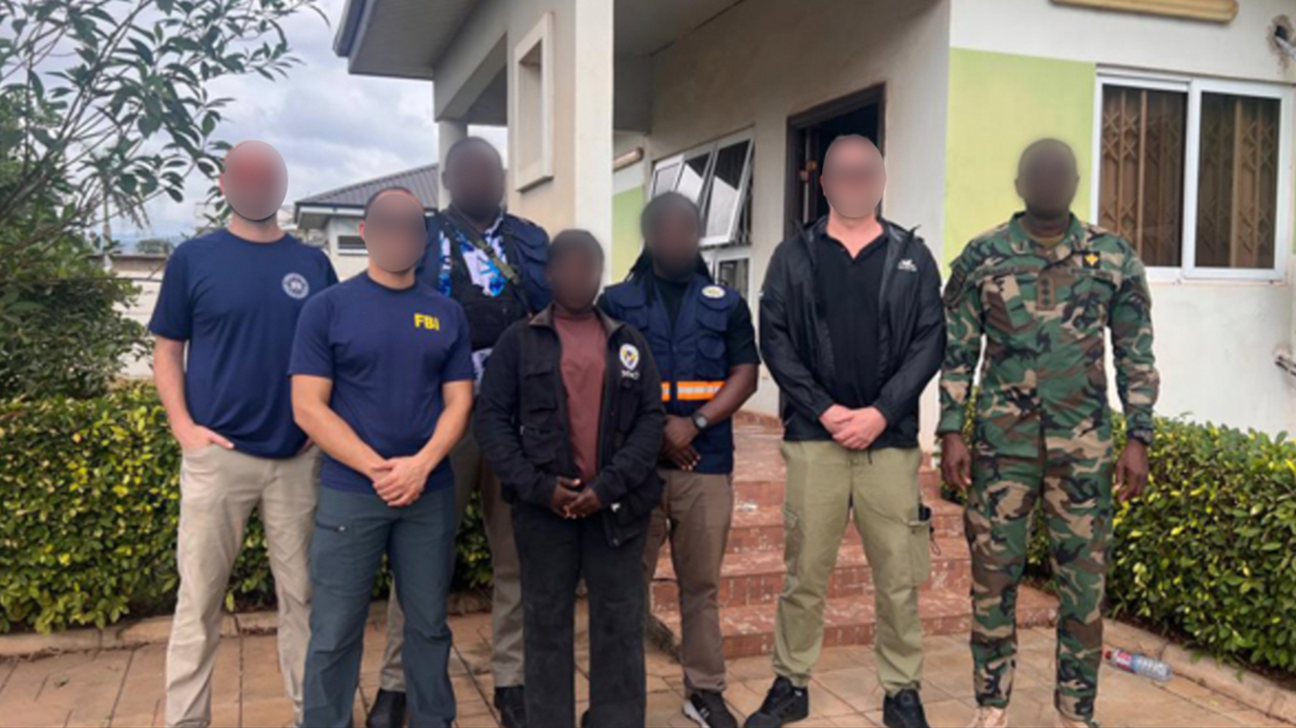 FBI personnel and other individuals pictured outside a building in Ghana
