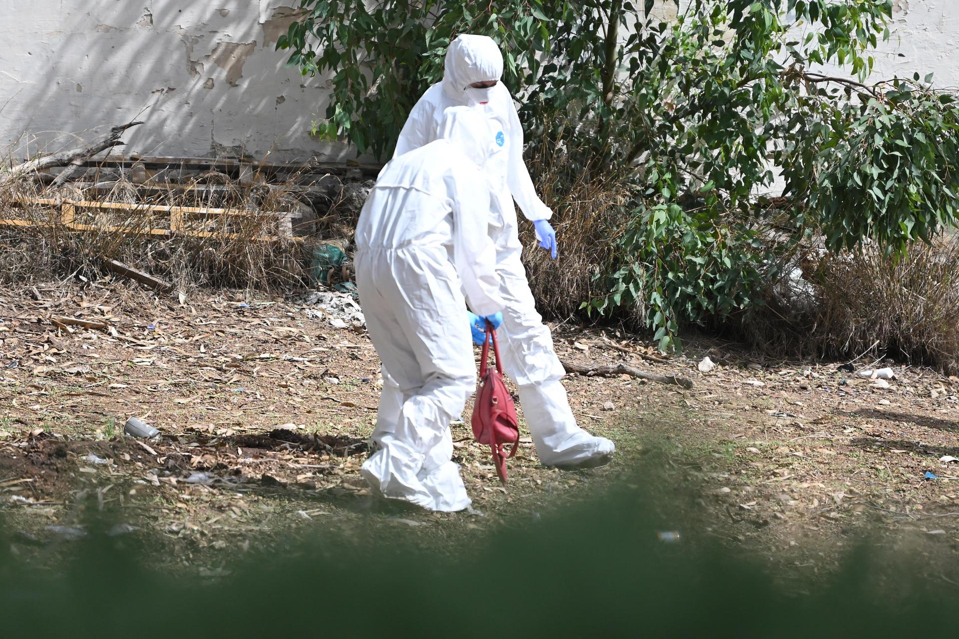 Supplied photograph of forensic workers at a field in Marsa