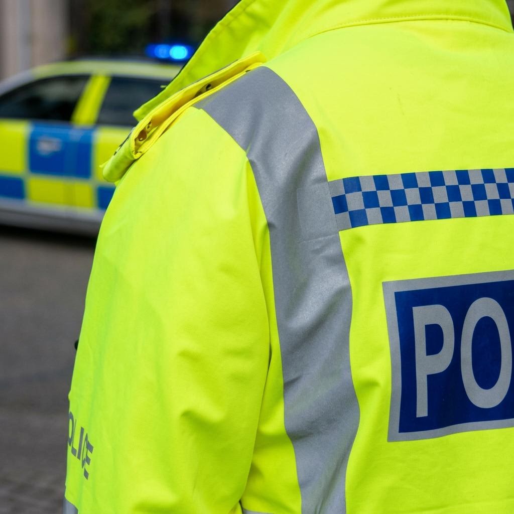 Police Scotland officer and marked police vehicle in a supplied Glasgow operation photograph
