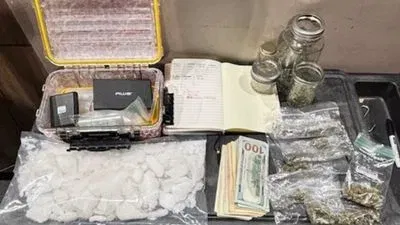 Supplied photo showing suspected drugs, cash, scales, ledger, and glass items from the vehicle search